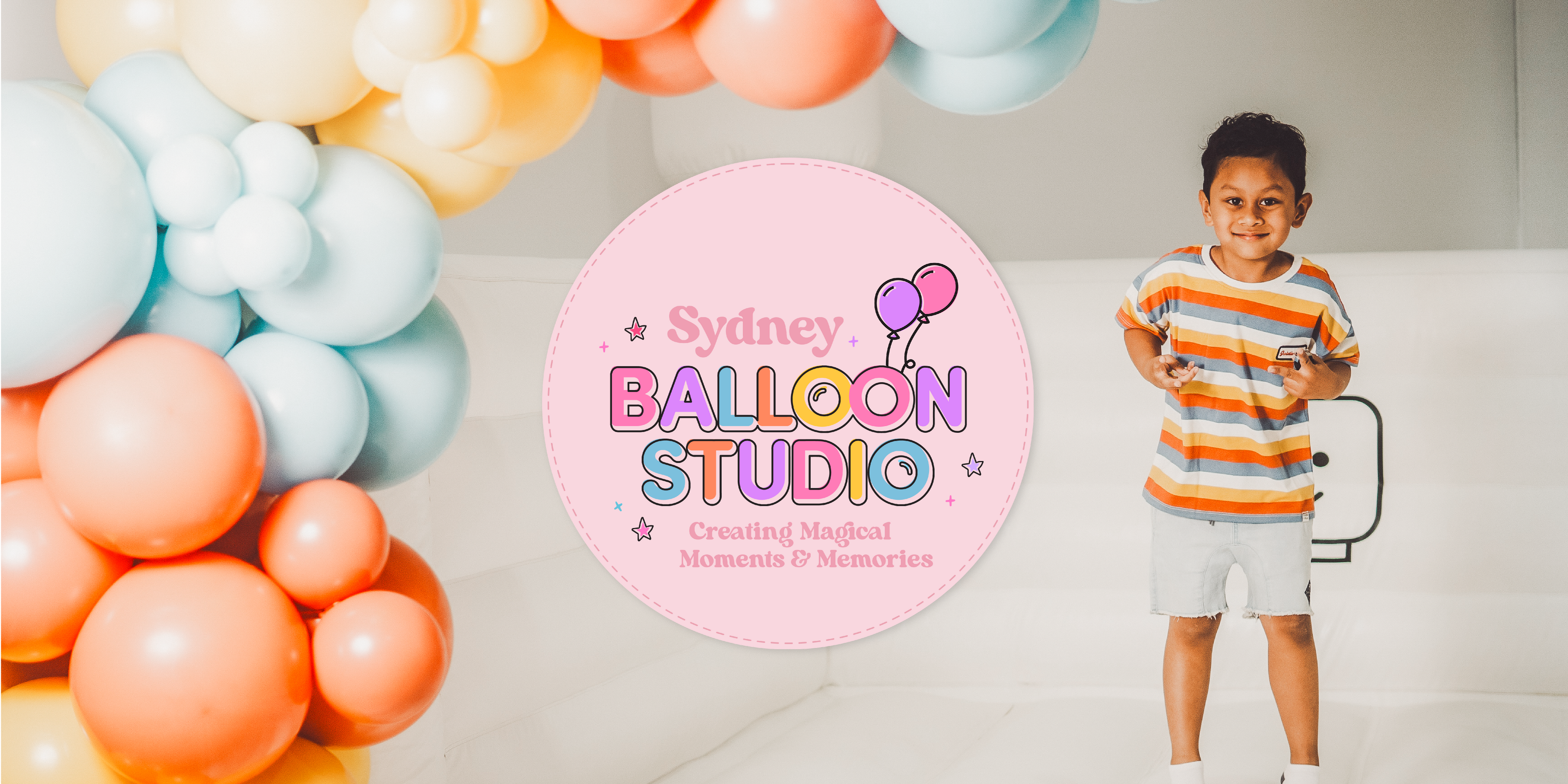 Sydney Balloon Studio main banner image with boy on castle and balloon garland